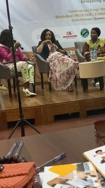 Women speakers on stage during a panel conversation